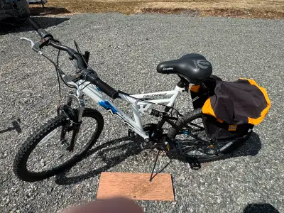 White mountain bike with rear and front suspension 12 speeds. Accessories includes luggage rack and...