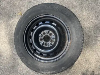 Offering a set of four Michelin X-Ice tires, size 215/60 R16, mounted on steel rims. These winter ti...