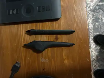 This is a used Wacom drawing tablet, perfect for artists and designers. It comes with two pens and a...