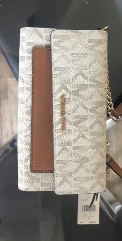 I'm selling a new Michael Kors wallet that features an all-over logo print and a detachable chain-li...