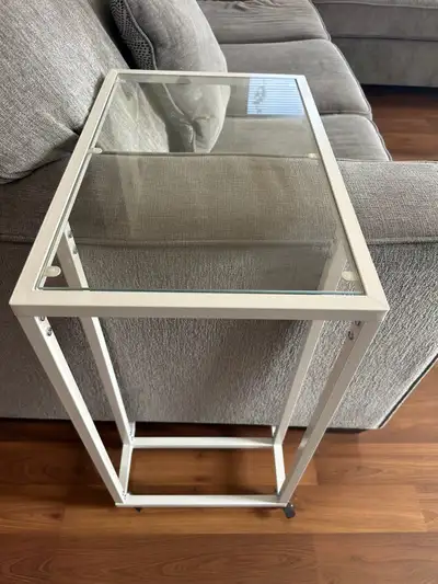 Add a touch of modern elegance to your living space with this sleek glass end table. Its clean lines...