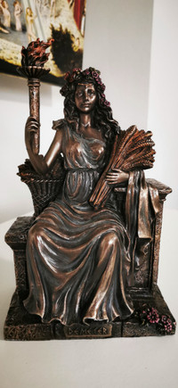Demeter Goddess of The Harvest Sitting On Bench Holding Wheat