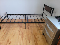 Two identical metal bed frames