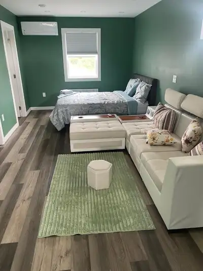 A spacious studio apartment for short-term rental. Amenities include water, hydro, and Wi-Fi, inclus...