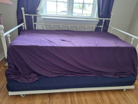 Daybed in excellent condition with  2 mattresses and bedding .