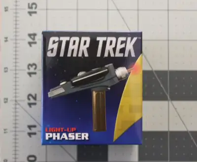 Selling a miniature Star Trek light up Phaser and book. Approximate Measurements Book: 2.5″ x 3″ x 0...