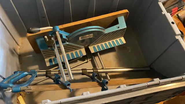 precision hand miter saw with a blue metal frame and wood base.