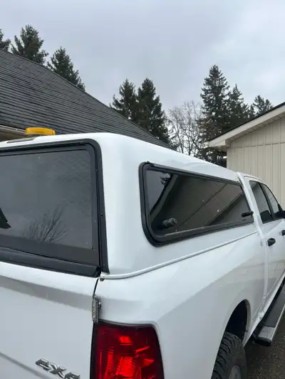 White truck topper off of a Dodge ram. 76” All windows and seals are intact Shocks all work