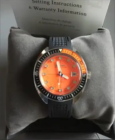function and sport style. It features a stainless steel case and bright orange dial with a black sup...