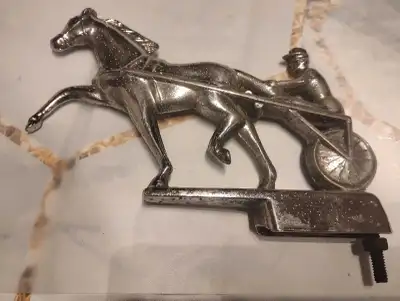 I am selling a vintage horse and chariot metal hood ornament. This unique piece features a detailed...