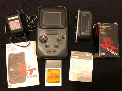 Selling a NEC PC Engine GT handheld gaming unit, along with analog TV tuner adapter. Includes the po...