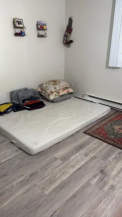 This clean, sunlit room is available for rent and offers a cozy, minimalist space perfect for a sing...