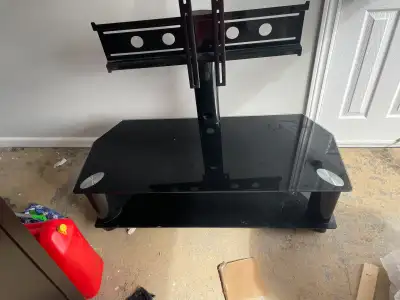 Modern black glass TV stand. Has integrated mount for your TV. Two shelves for media players, consol...