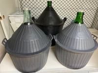 54 - large green glass wine making jar in plastic baskets
