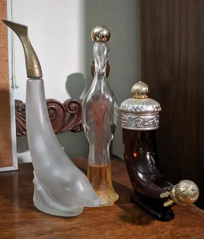 Here is a small collection of three Avon Perfume Bottles. There is a Brown Glass Horn, a clear tall...