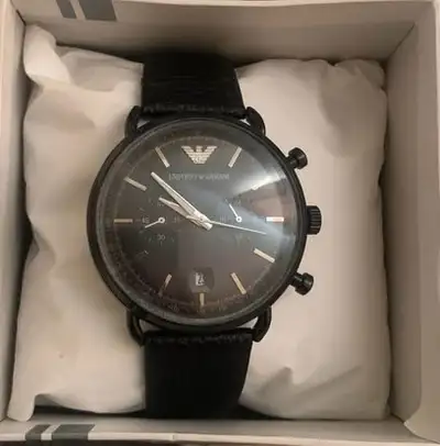 Selling a stylish Emporio Armani watch, in used but good condition. It features a sleek black design...