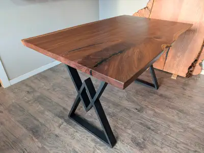 Newly finished live edge black walnut dining table. The top measures 40" wide x 66" long making it w...
