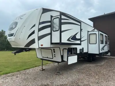 This beautiful fifth wheel checks all of the boxes whether you’re interested in setting up at a seas...