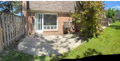 Bright townhouse has a brick exterior. Interior has light grey walls and light-colored laminate floo...