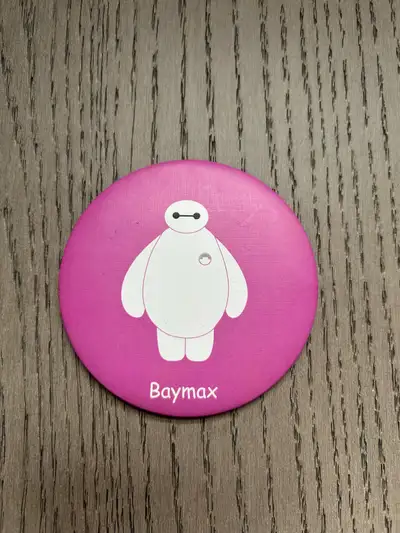 cute round pocket mirror featuring Baymax from Big Hero 6. It's small and portable, perfect for touc...