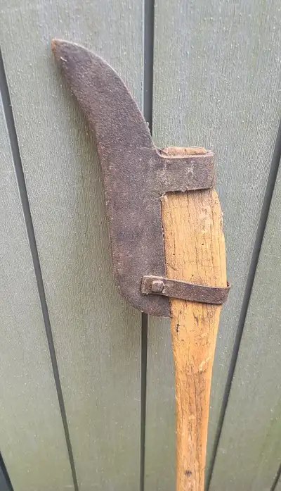 Primitive old antique billhook or brush axe with a curved blade , View more