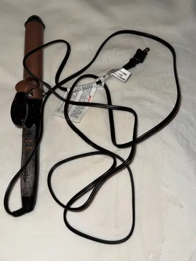 Conair instant heat curling iron in a bronze colour. It's a styling tool for creating curls and wave...