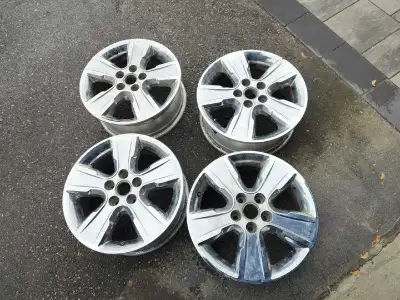 Available is a set of used rims with a 5-bolt pattern, showing signs of wear but structurally sound...