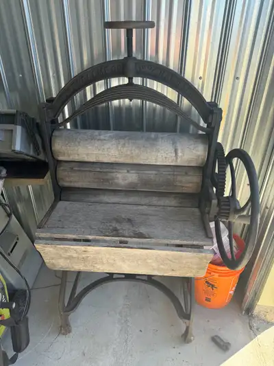 Step back in time with this antique Dowswell MFG CO. United Hamilton Ontario wringer washing machine...