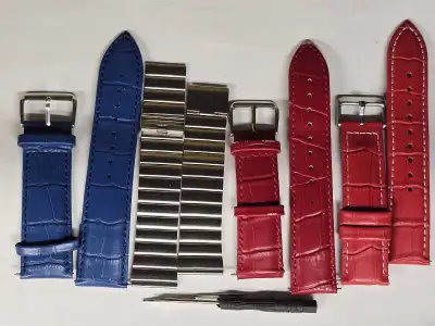 four pairs watch bands: blue leather, two red leather, and one stainless steel. Includes spring bars...