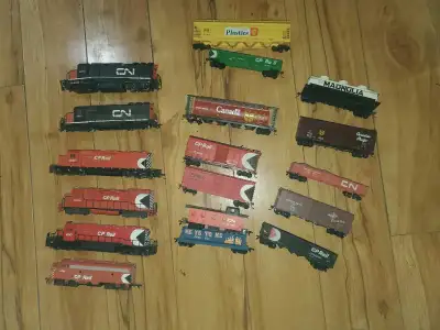 I'm selling a box filled with model train stuff, including train cars from CN and CP Rail, tracks, a...