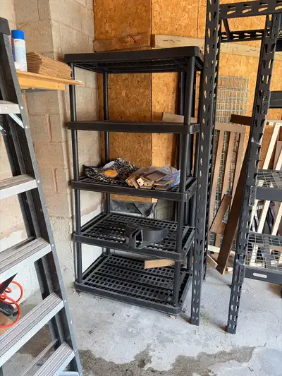 This is a used heavy-duty black plastic shelving unit, perfect for organizing your garage, basement,...