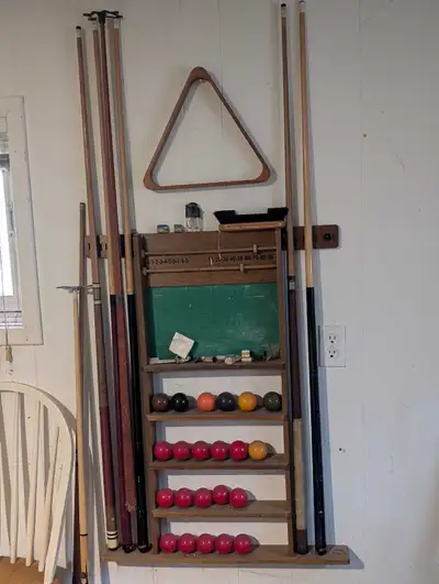 Antique full slate, solid wood pool table. Comes with all equipment; including pool cues, racks, rak...
