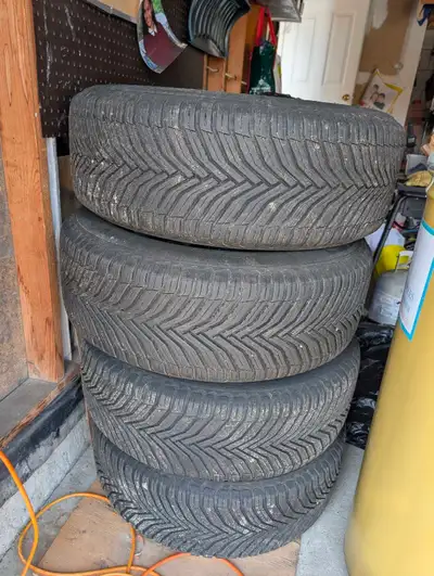 Durable Michelin CrossClimate tires in size 255/60 R18. This set of four tires is mounted on silver...