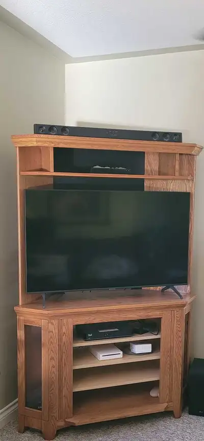 Fits 50 inch flat screen TV lol. We put in shelves instead of electric fireplace. Bought with one gl...