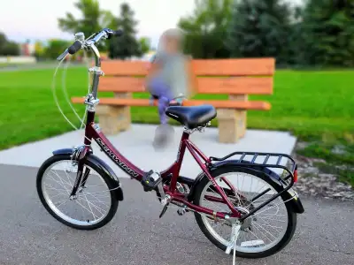 Foldable bike. Schwinn brand. It has a comfortable black seat, fenders, and a rear cargo rack. Bike...