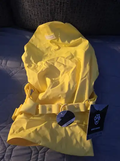 Keep your furry friend dry and stylish with this brand new yellow dog raincoat! this raincoat is per...