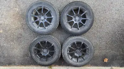 Set of 4 winter tires mounted on black alloy rims, previously used on a 2024 Nissan Kicks S. Details...