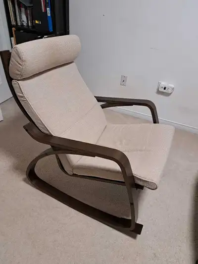 This is an Ikea Poang rocking chair, perfect for adding a touch of relaxation to any room, featuring...