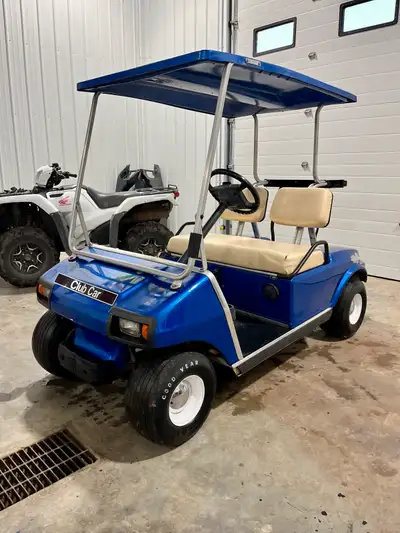 1997 club car Gas powered Electric blue paint with baby moon wheels Jump in and go Has head lights a...