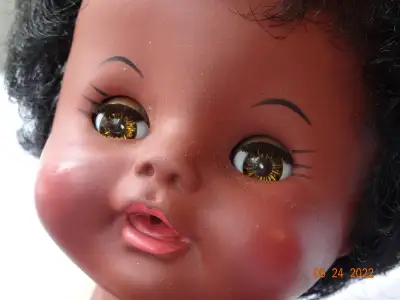 15 inch native doll , or toddler, wearing cutest white dotted onesie. Perfect lashes, brown eyes, se...