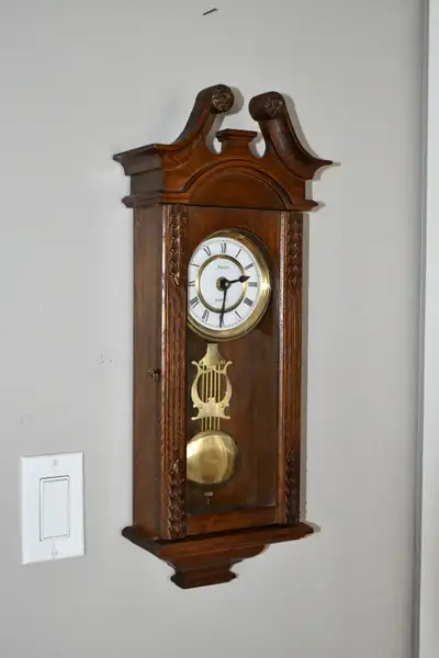 Wall clock in walnut case., View more