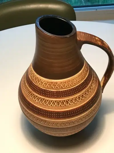 Add a touch of mid-century modern charm to your home with this Dumler & Breiden ceramic pitcher, sho...