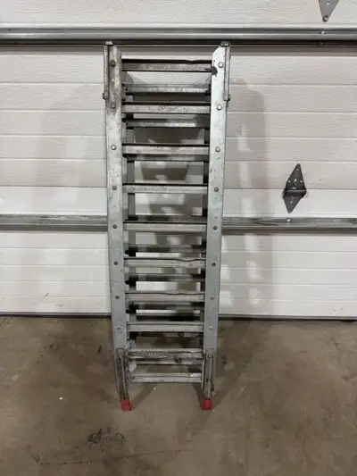 Heavy-duty foldable aluminum ramp perfect for loading dirt bikes, ATVs, or equipment into a truck be...