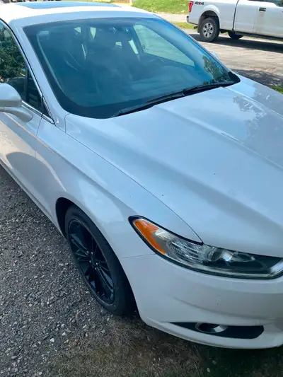Looking for a sleek and reliable ride? This white 2016 Ford Fusion handles the road like a dream. Wi...