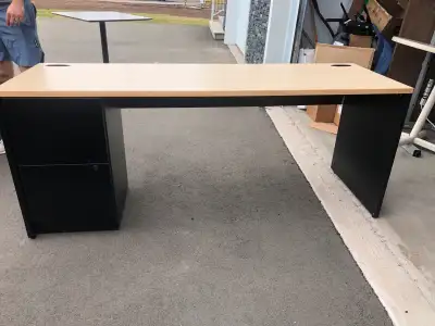 This is a sturdy black and wood-look desk perfect for any home office setup. It features a built-in...