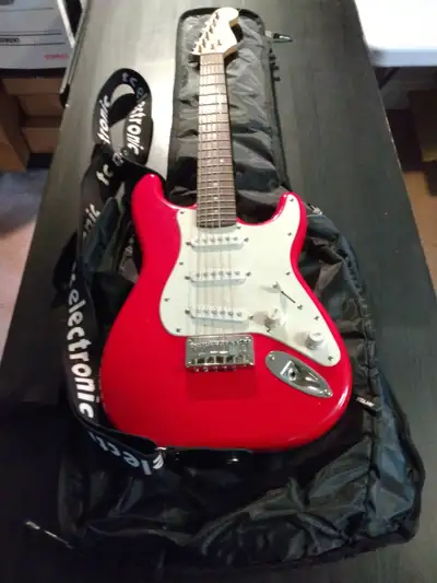 Fender Squier Mini with soft shell gig bag, strap, picks, and patch cord.