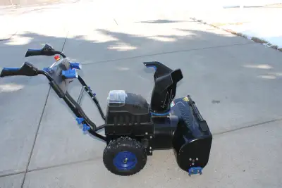 Snow joe snow blower like new with 3 froward speeds, 2 stage, electric chute, lights and powered by...