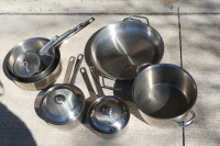 A collection of stainless steel pots and pans