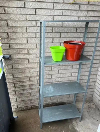 This is a three-tier shelf unit, perfect for organizing plants or displaying items on a balcony or i...