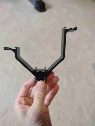 A camera/camcorder mount that can hold 3 items, such as remote, wireless mic receiver, shotgun mic o...